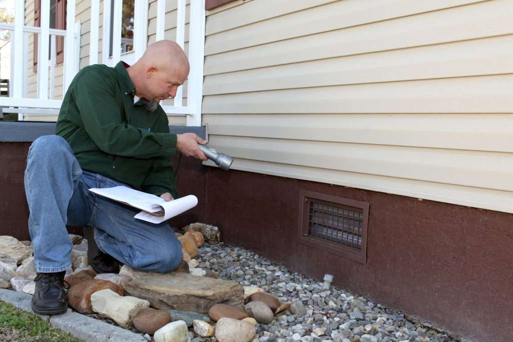 Home building inspector checking the foundation